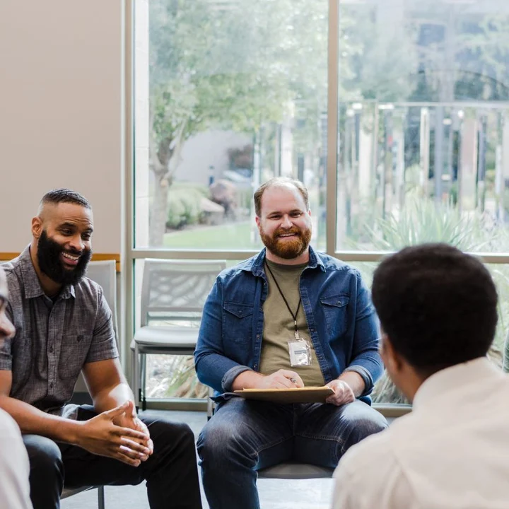 A group of men talking together in a circle